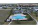 An aerial view of the community pool showing the surrounding neighborhood and well-maintained grounds at 9009 Pinales Way, Kissimmee, FL 34747