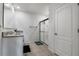 Bathroom featuring single vanity with granite counters, tile floor, and walk-in shower with glass door at 9009 Pinales Way, Kissimmee, FL 34747