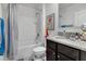 Bathroom with shower/tub combo, granite countertop, and stylish fixtures at 9009 Pinales Way, Kissimmee, FL 34747