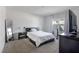 Bedroom with carpet, large mirror, dark wood dresser, and white curtains at 9009 Pinales Way, Kissimmee, FL 34747