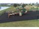 View of the community playground featuring modern play equipment surrounded by a safety mulch surface at 9009 Pinales Way, Kissimmee, FL 34747