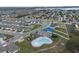 Overhead view of a residential neighborhood featuring community amenities and houses, showcasing the area's layout at 953 Cambridge Dr, Winter Haven, FL 33881