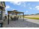 Backyard patio with stone pavers, featuring an outdoor dining area with furniture at 953 Cambridge Dr, Winter Haven, FL 33881