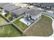 Aerial view of a fenced backyard featuring a modern patio with a gazebo and well-maintained lawn at 953 Cambridge Dr, Winter Haven, FL 33881