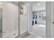 Bathroom featuring a walk-in shower with glass doors adjacent to a walk-in closet at 953 Cambridge Dr, Winter Haven, FL 33881