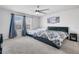 Bright bedroom featuring plush carpeting, a ceiling fan, and a window bringing in natural light at 953 Cambridge Dr, Winter Haven, FL 33881