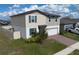 Charming two-story home featuring a two-car garage and well-maintained landscaping at 953 Cambridge Dr, Winter Haven, FL 33881