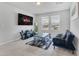 Inviting living room space with a sleek entertainment center, cozy seating, and ample natural light at 953 Cambridge Dr, Winter Haven, FL 33881