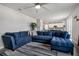 Inviting living room featuring a large blue sectional sofa and a stylish area rug at 953 Cambridge Dr, Winter Haven, FL 33881