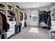 Spacious walk-in closet with custom shelving, hanging racks, and natural light from a window at 953 Cambridge Dr, Winter Haven, FL 33881