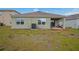 Exterior of home with covered patio and a well-maintained backyard at 1031 August Sky Dr, Deltona, FL 32738