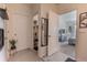 Hallway view showing half-bathroom, decorated with lovely wall hangings at 1031 August Sky Dr, Deltona, FL 32738