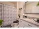 Well-lit bathroom with granite countertops, modern fixtures, and decorative plants on floating shelves at 1031 August Sky Dr, Deltona, FL 32738