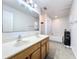 Bright bathroom with a double sink vanity, tile flooring, and large mirror at 10409 Laxton St, Orlando, FL 32824