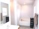 Bright bathroom featuring a soaking tub and window at 10409 Laxton St, Orlando, FL 32824