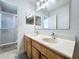 Bright bathroom features double sinks, a shower, and a large mirror at 10409 Laxton St, Orlando, FL 32824