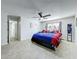 Spacious bedroom featuring tiled floors and fan, next to doorway at 10409 Laxton St, Orlando, FL 32824