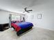 This bright bedroom features a ceiling fan, a window with blinds, and tile flooring at 10409 Laxton St, Orlando, FL 32824