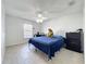 This bedroom features tile floors, a ceiling fan, a window with blinds, and a bed with a dinosaur at 10409 Laxton St, Orlando, FL 32824