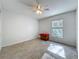 Bright bedroom featuring tile flooring, ceiling fan, and window, providing ample natural light at 10409 Laxton St, Orlando, FL 32824