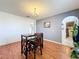 Dining room featuring wood floors, lots of light and arched doorway into other areas of the home at 10409 Laxton St, Orlando, FL 32824