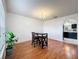 Bright dining area with hardwood floors, chandelier, and views of the kitchen at 10409 Laxton St, Orlando, FL 32824