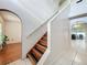 Bright entryway featuring a staircase, arched doorways, and tile and wood flooring at 10409 Laxton St, Orlando, FL 32824