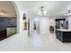 Hallway features arches, white tile flooring, and natural light at 10409 Laxton St, Orlando, FL 32824