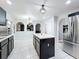 Modern kitchen featuring an island with black cabinets, white countertops, and stainless steel appliances at 10409 Laxton St, Orlando, FL 32824