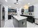 Modern kitchen with stainless steel appliances, center island, and black cabinets at 10409 Laxton St, Orlando, FL 32824