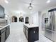 Modern kitchen featuring black cabinets, stainless steel appliances, tile floors and a center island at 10409 Laxton St, Orlando, FL 32824