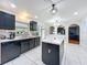 Modern kitchen featuring black cabinets, stainless steel appliances, tile floors and a center island at 10409 Laxton St, Orlando, FL 32824