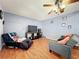 Living room with wood flooring, ceiling fan, television, and couches at 10409 Laxton St, Orlando, FL 32824