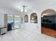Open living space with arched doorways and sliding glass door leading to back patio at 10409 Laxton St, Orlando, FL 32824