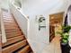 Staircase with wood treads and black risers, leading to the upper level with laundry area at 10409 Laxton St, Orlando, FL 32824