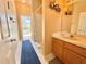 A bright bathroom with a vanity, shower, and access to an outdoor space at 106 Southern Pine Way, Davenport, FL 33837