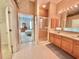 Bathroom featuring double sinks, a walk-in shower, and view to the main bedroom at 106 Southern Pine Way, Davenport, FL 33837