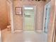 Bathroom area featuring a walk-in closet and beige patterned wallpaper at 106 Southern Pine Way, Davenport, FL 33837