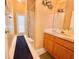 A well-lit bathroom featuring a vanity, shower, and a door to the outside at 106 Southern Pine Way, Davenport, FL 33837