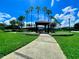 A park with a covered picnic pavilion, lush green grass, manicured landscaping, and beautiful palm trees at 106 Southern Pine Way, Davenport, FL 33837