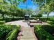 Beautiful view of a memorial in a manicured park with a walkway, benches, and mature trees at 106 Southern Pine Way, Davenport, FL 33837