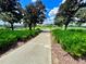 Scenic community path with lush greenery and a beautiful view of the surrounding landscape at 106 Southern Pine Way, Davenport, FL 33837