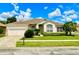 Charming single-story home featuring a manicured lawn, lush landscaping, and a two-car garage at 106 Southern Pine Way, Davenport, FL 33837