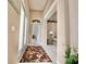 Inviting home hallway features a decorative rug and offers a glimpse into adjacent rooms at 106 Southern Pine Way, Davenport, FL 33837