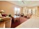 A bright living room featuring neutral decor, carpet, and large windows at 106 Southern Pine Way, Davenport, FL 33837