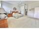 Spacious main bedroom featuring artwork, a ceiling fan, and matching night stands on either side of the bed at 106 Southern Pine Way, Davenport, FL 33837