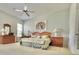 Spacious main bedroom featuring a ceiling fan and matching night stands on either side of the bed at 106 Southern Pine Way, Davenport, FL 33837