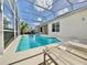 Sun-drenched pool features a screen enclosure, with comfortable lounge chairs and a serene backyard at 106 Southern Pine Way, Davenport, FL 33837