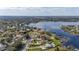 Breathtaking aerial of lakefront property featuring lush landscape and neighborhood views at 10919 Lakeshore Dr, Clermont, FL 34711