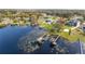 Aerial shot of a lakeside home with boat docks, green lawn, and access to water activities at 10919 Lakeshore Dr, Clermont, FL 34711